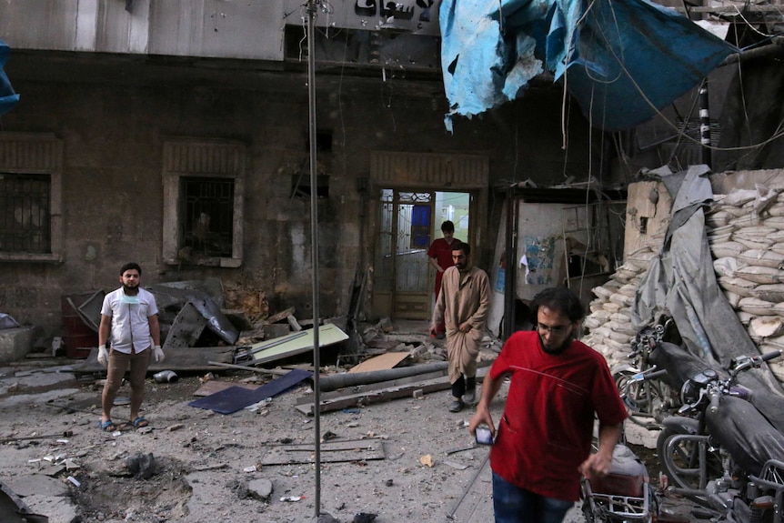 Medics inspect the damage outside a field hospital.