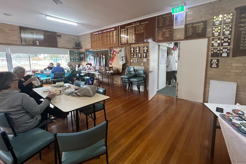 big room at the bowls club with the queen's portrait above the door