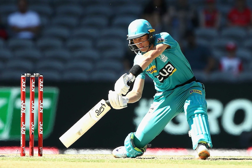 Marnus Labuschagne stands with his legs wide apart and leans into a shot, played with an angled cricket bat