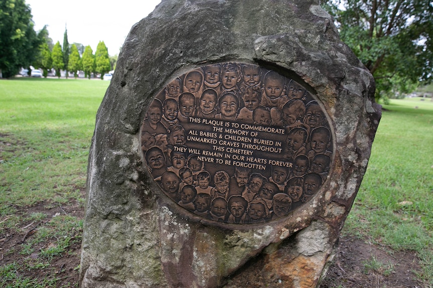A plaque with babies' faces commemorates the babies and children buried in unmarked graves throughout Rookwood Cemetery.