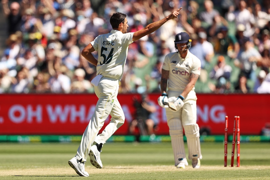 Australia bowler Mitchell Starc points away after bowling England batter Ben Stokes during an Ashes Test at the MCG.