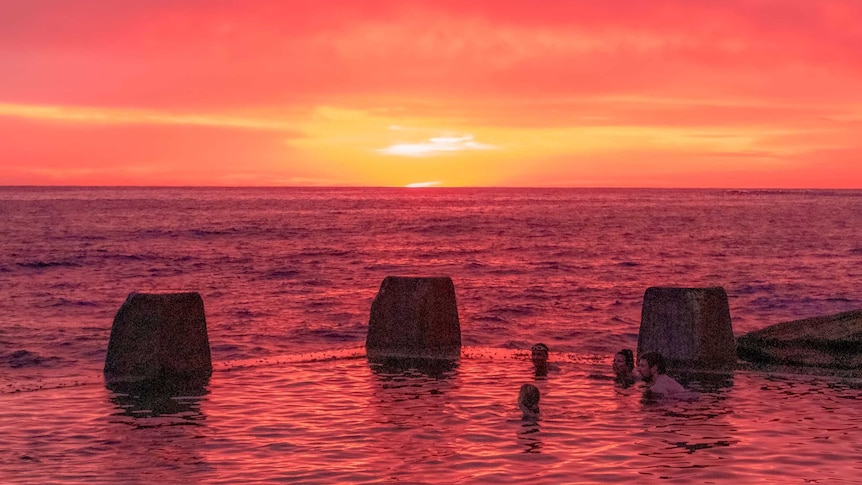 A raspberry red sunrise over Coogee beach