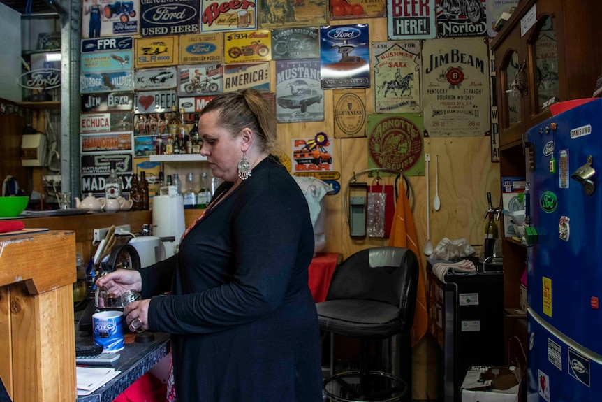 A woman cooking lunch in the shed.