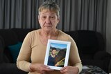 Rosemary Harwood holds a photo of her transgender daughter Marjorie.-
