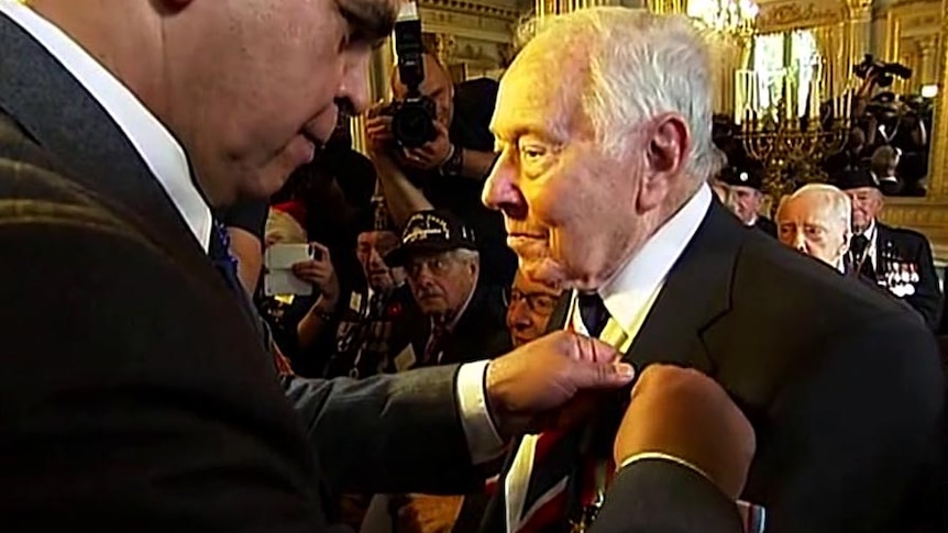 Phil Elger receives his Legion of Honour during a ceremony in the town of Caen in Normandy.
