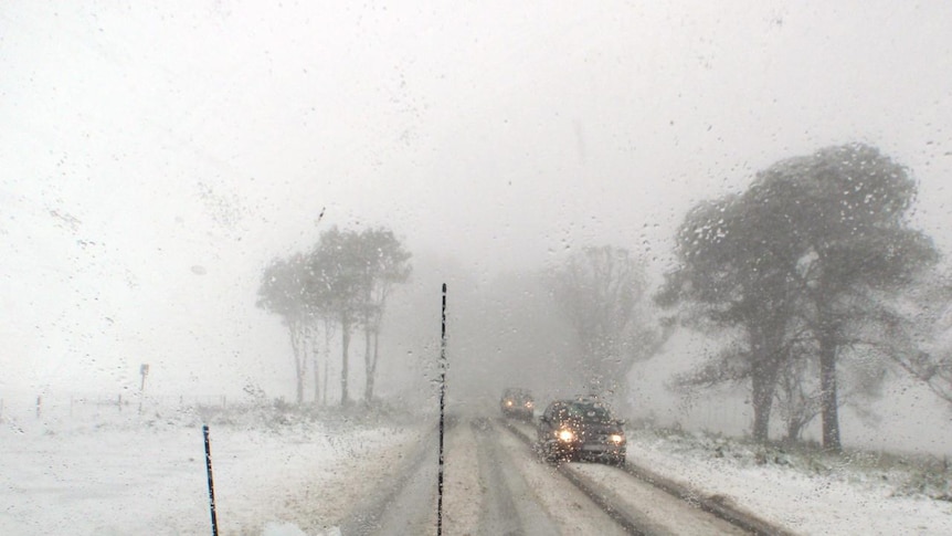 Snow covers the road between Kinglake and Kinglake West after a cold snap brought snow to the region.