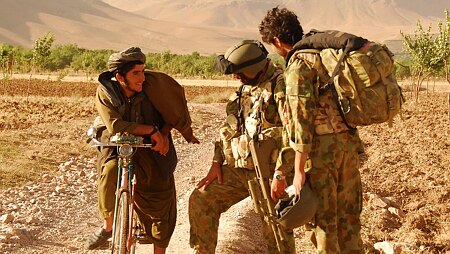 Australian soldiers talk to local Afghan man