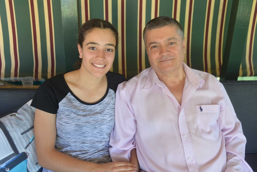 Year 12 student Amar Hadid sits with her father Albert at their home in Greenacre.
