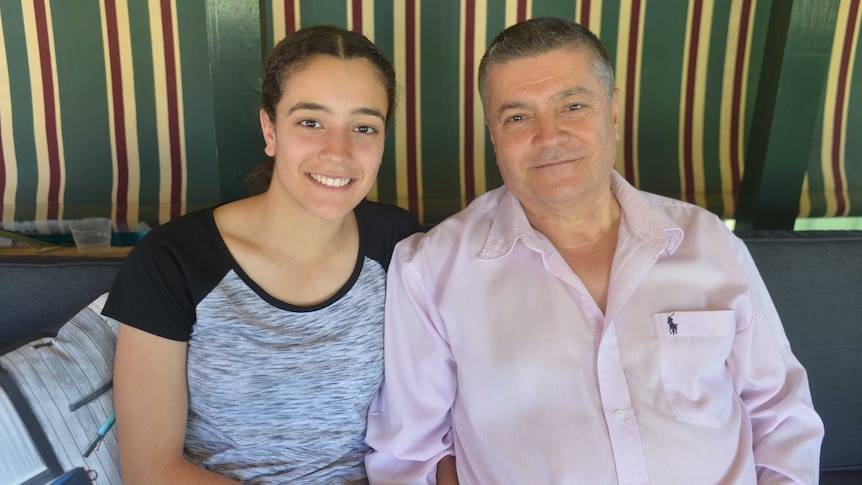 Year 12 student Amar Hadid sits with her father Albert at their home in Greenacre.