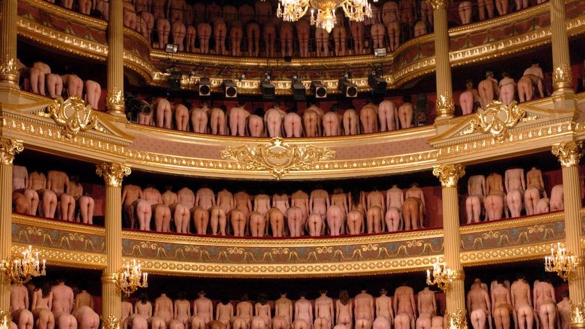 Volunteer participants pose naked inside the Stadschouwburg theatre