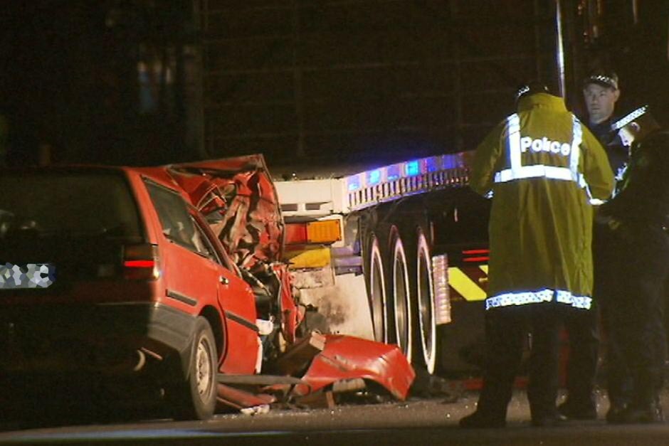 A car crashed into a semitrailer.
