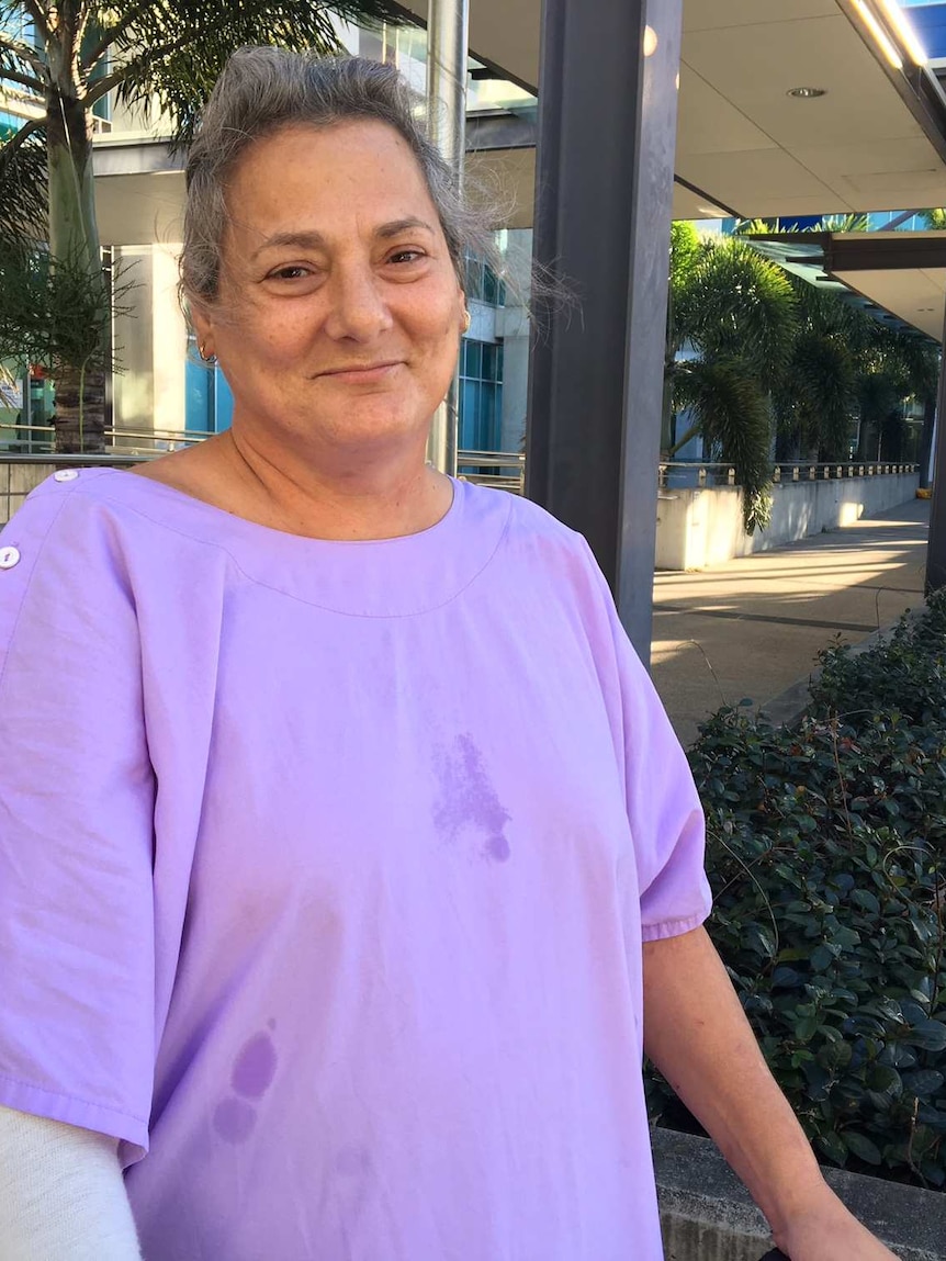 A woman in a purple dress gown outside Royal Brisbane and Women's Hospital.