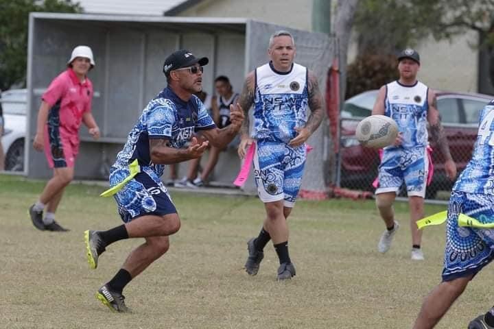 First Nations man Jamie Archibald running with a football during a game of professional Oztag
