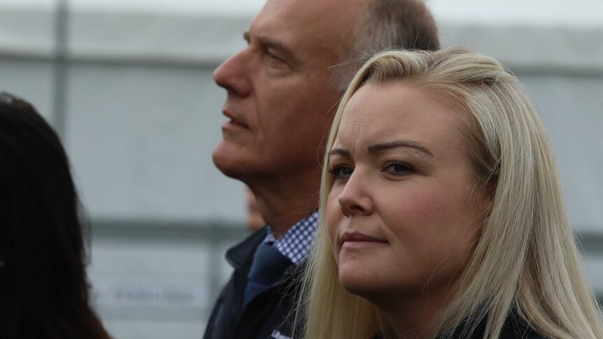Jessica Whelan looks to her left towards the camera as eric ebetz looks in a different direction