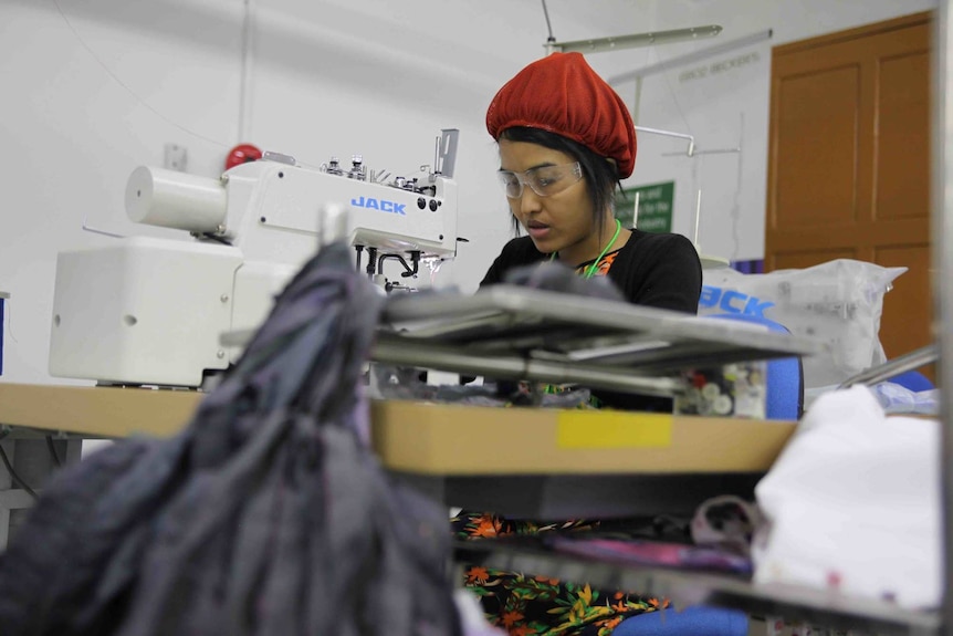 A garment worker on a sewing machine