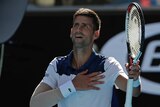 Novak Djokovic with his right hand over his heart as he looks to the Melbourne Park crowd at the Australian Open.
