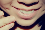 A close up of a girl smiling.