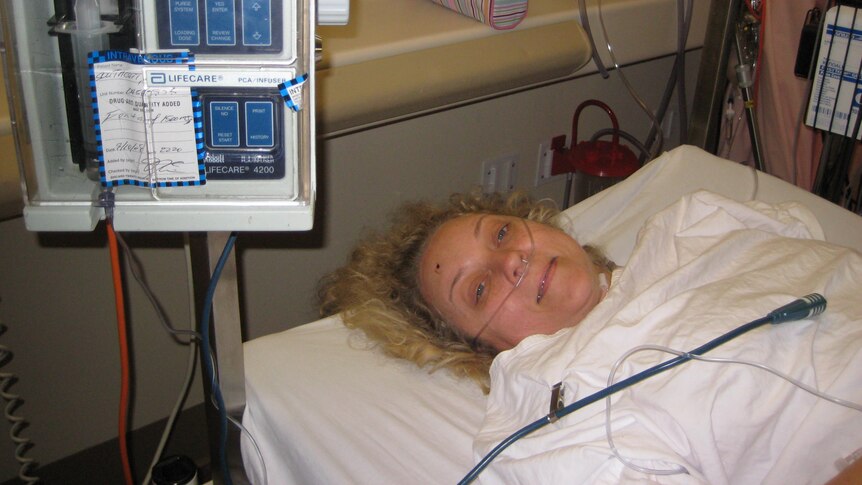 Caroline laying in a hospital bed
