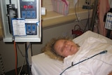 Caroline laying in a hospital bed