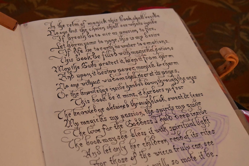 Page of book with curly writing.