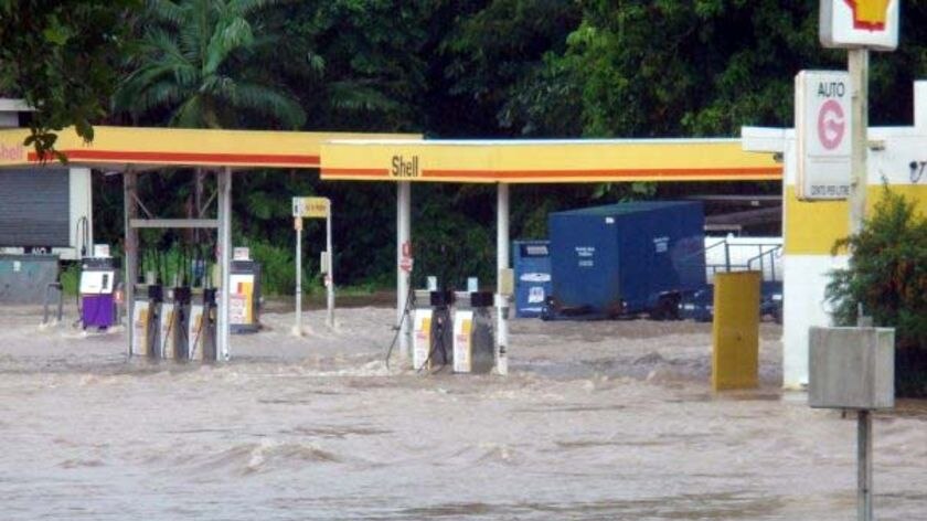 Floodwaters lap at the bowsers at a petrol station in the north Queensland town of Ingham