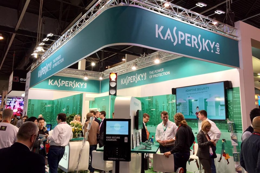 Kaspersky Lab staff work at a booth at a technology event.