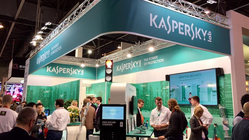 Kaspersky Lab staff work at a booth at a technology event.