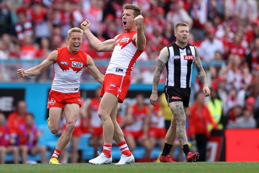 Seorang pemain Sydney Swans AFL mengepalkan tangannya saat merayakan gol ke gawang Collingwood.