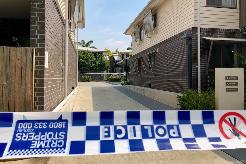 Police tape across a driveway of a unit complex in Yeronga, Brisbane