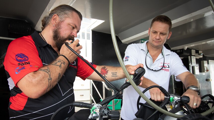 Two men test diving equipment