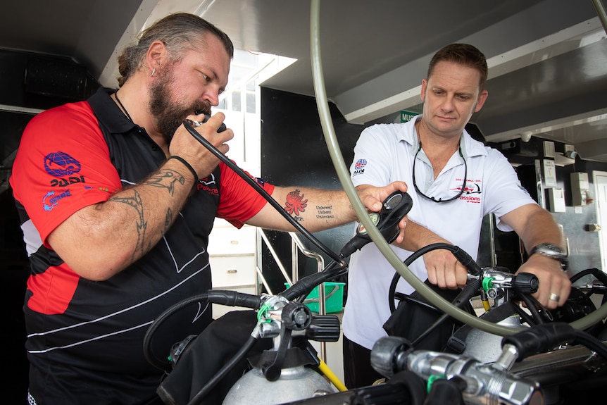 Two men test diving equipment