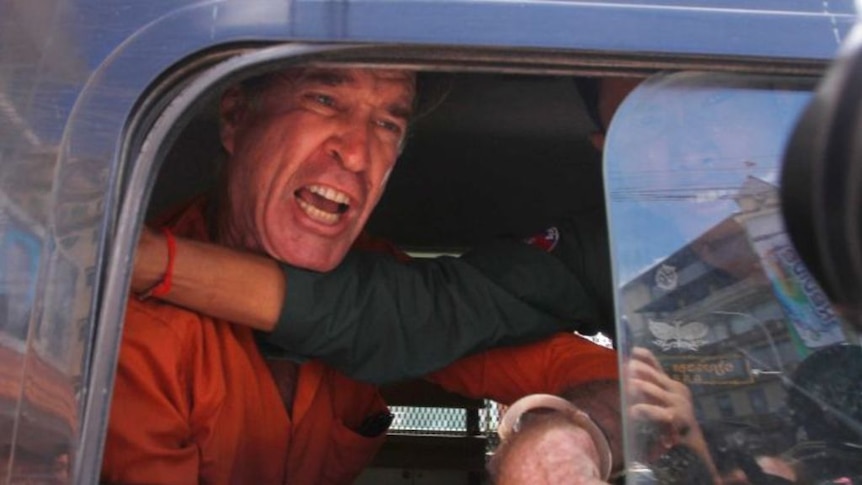'Who am I spying for?' James Ricketson yells while being driven from court (Photo: AP/Heng Sinith)