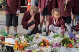 School children praying and offering prayers at a memorial to the Christchurch victims