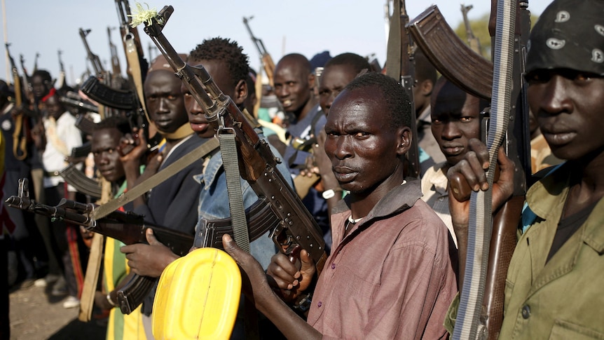 Jikany Nuer White Army fighters holds their weapons and look into the camera.