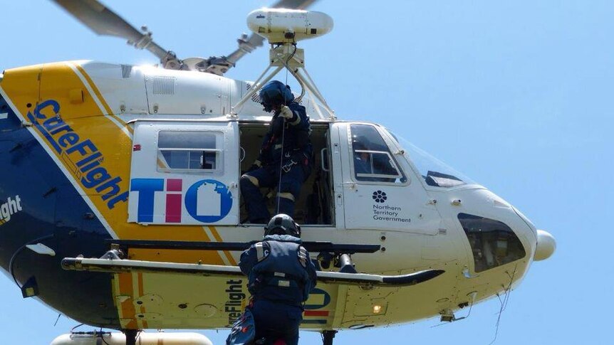 A doctor jumps out of a helicopter to rescue a patient in Darwin.