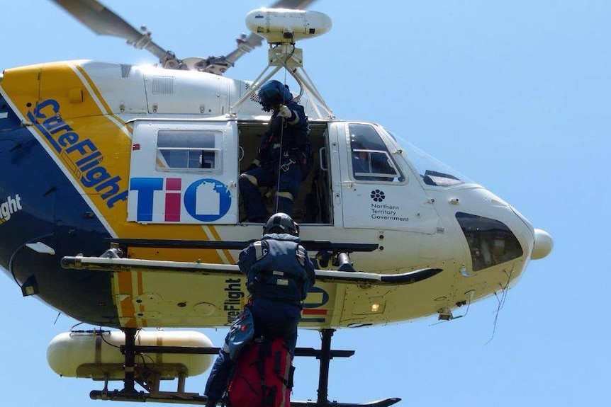 A doctor jumps out of a helicopter to rescue a patient in Darwin.
