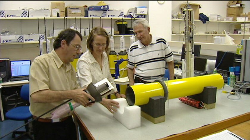 CSIRO scientists in Tasmania with a robotic buoy which has measured ocean temperatures.