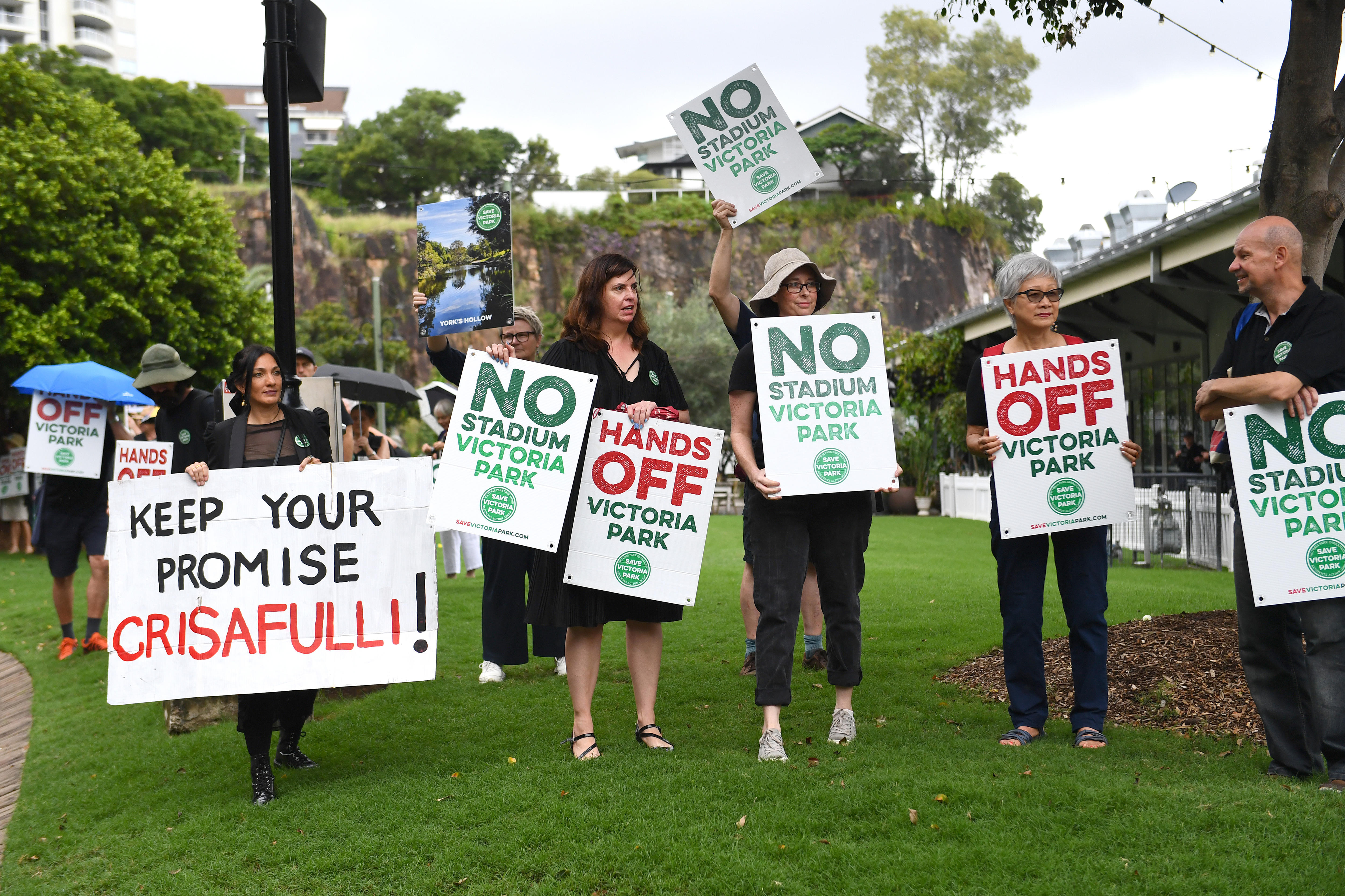 People withplacards saying thinsgs like "save Victoria Park" and "Keep your promise".
