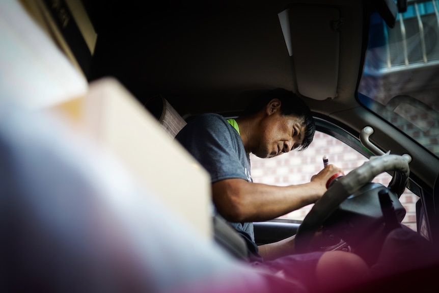 Lee Seong Wook behind the wheel of his van.