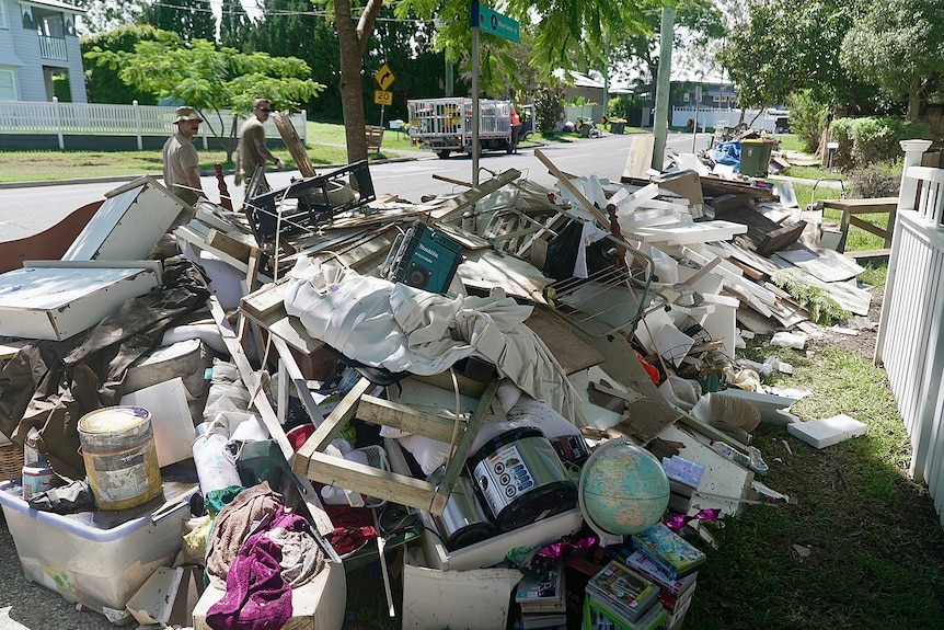 Rubbish lines a street in Chelmer in Brisbane after the flood event.