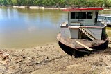 A house boat on the banks of a river