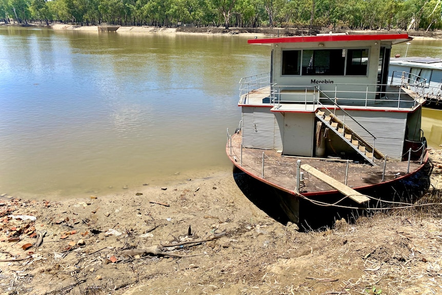 A house boat on the banks of a river