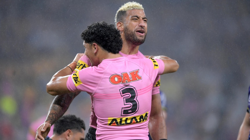 Two Penrith Panthers NRL players embrace after a try was scored against Melbourne Storm
