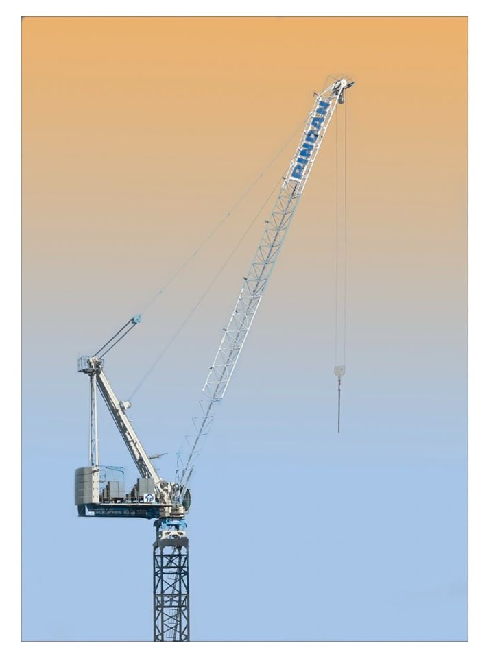 A large construction crane at sunset.