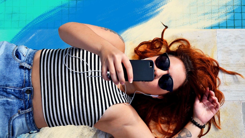 Woman on phone by the pool for a story on different standards of beauty