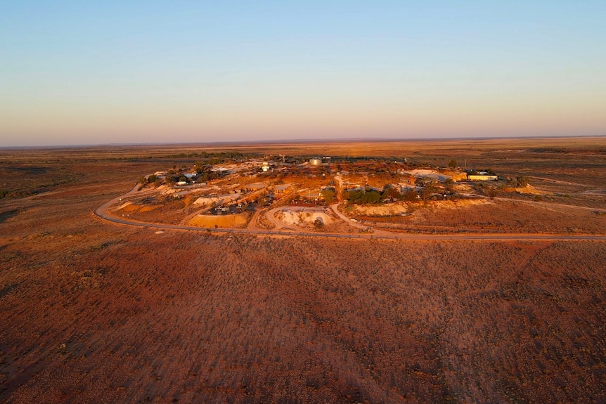 An early morning drone shot of a hill with underground homes built into it at White Cliffs, in outback NSW. 