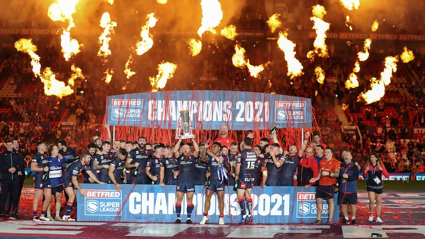 Fire is blasted into the air and confetti rains down as St Helens celebrates with the Super League trophy