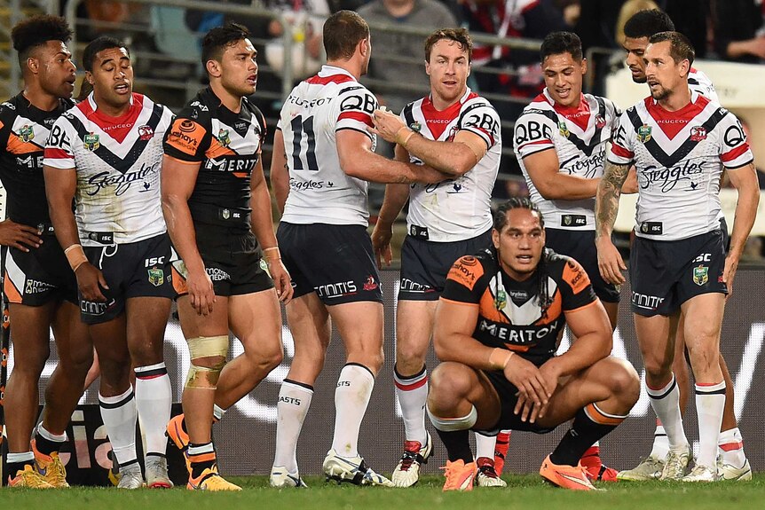 The Roosters celebrate a try against the Tigers