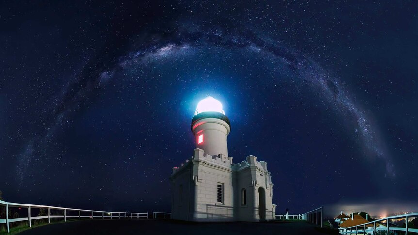 Stars in arc over lighthouse