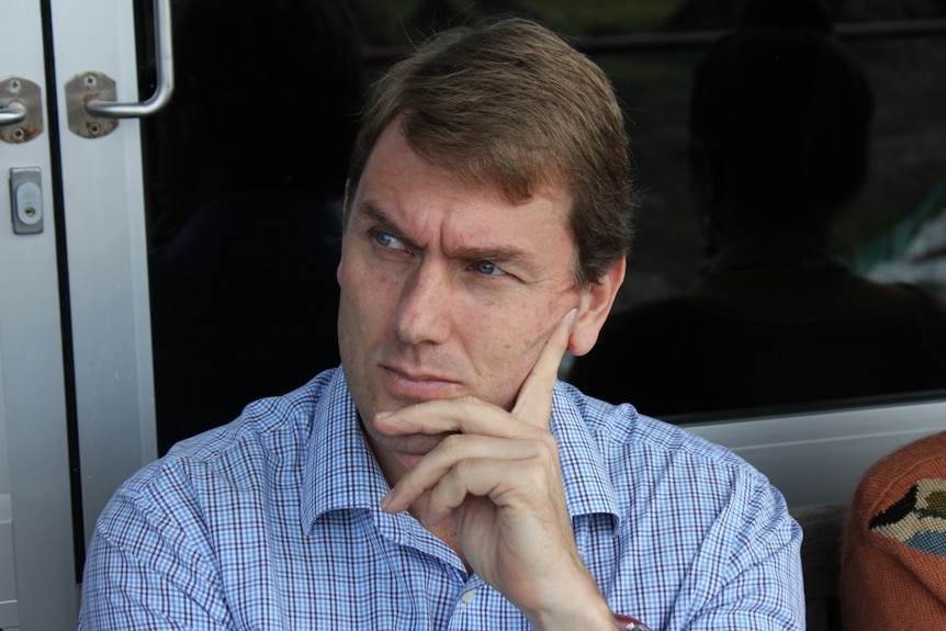 man sitting pondering resting on hand